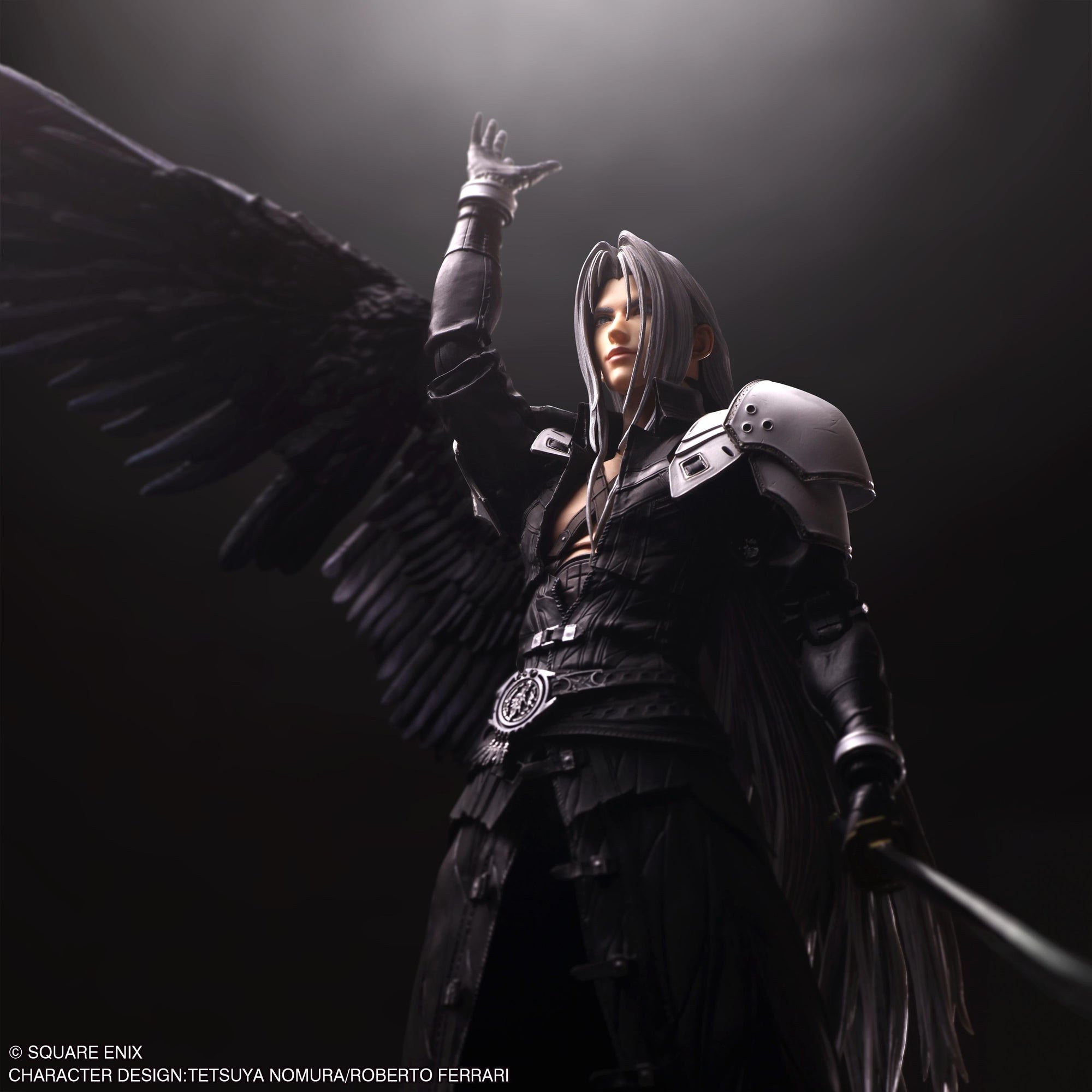 Low angle shot of Sephiroth Play Arts Shin figure with black wing reaching hand upward under spotlight.