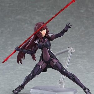 Low-angle dynamic lunging pose of the Fate/Grand Order Scathach figma figure wielding a long red lance overhead with a shouting combat expression.