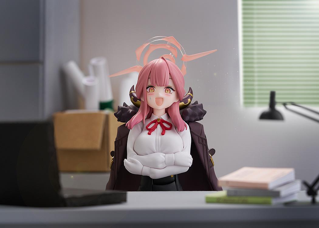 Aru Rikuhachima figma sitting at a desk with crossed arms and a nervous sweating facial expression.