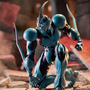 Highly articulated Guyver I figma in a kneeling battle-ready pose on a detailed debris diorama.