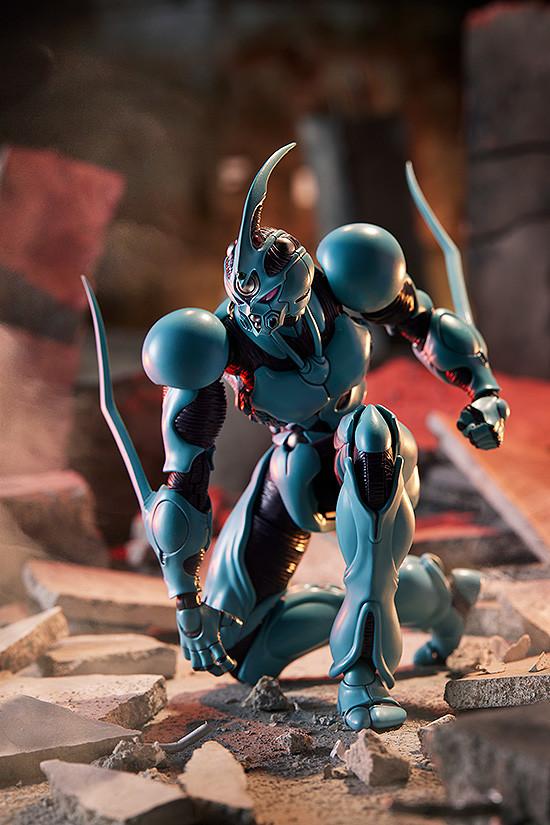 Highly articulated Guyver I figma in a kneeling battle-ready pose on a detailed debris diorama.