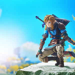 Cinematic shot of figma Link kneeling on a rock wearing the Hylian Hood against a bright sky background.