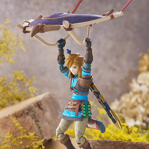 Link figma figure dynamically posed in mid-air holding the Paraglider accessory from Tears of the Kingdom.