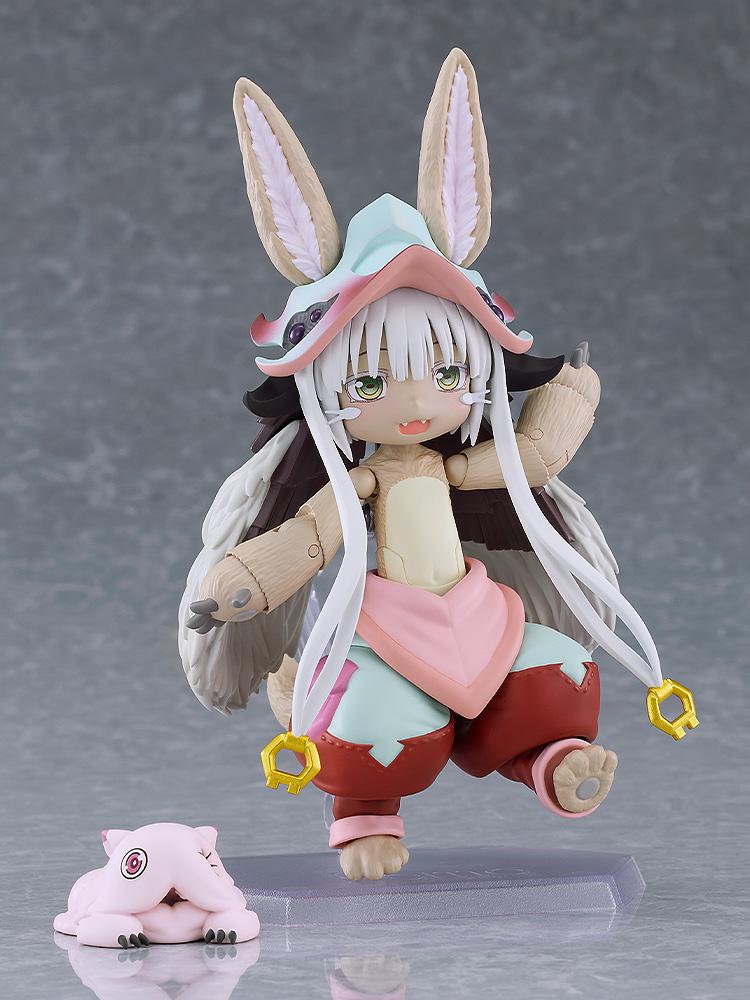 Dynamic side-stepping pose of the figma Nanachi action figure showing full articulation, big ears, and long white tassels.