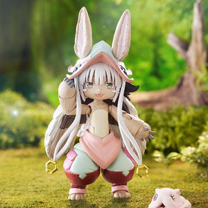 Promotional diorama photo of the figma Nanachi figure standing in a lush green forest background next to Mitty.