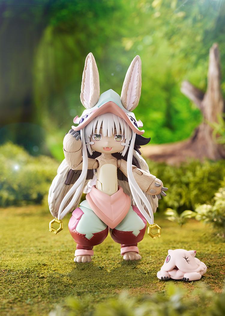 Promotional diorama photo of the figma Nanachi figure standing in a lush green forest background next to Mitty.