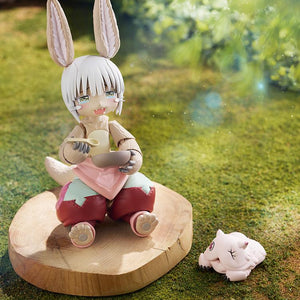 Scenic outdoor diorama shot of the figma Nanachi figure sitting on a wood slice eating from a bowl with her blissful expression.