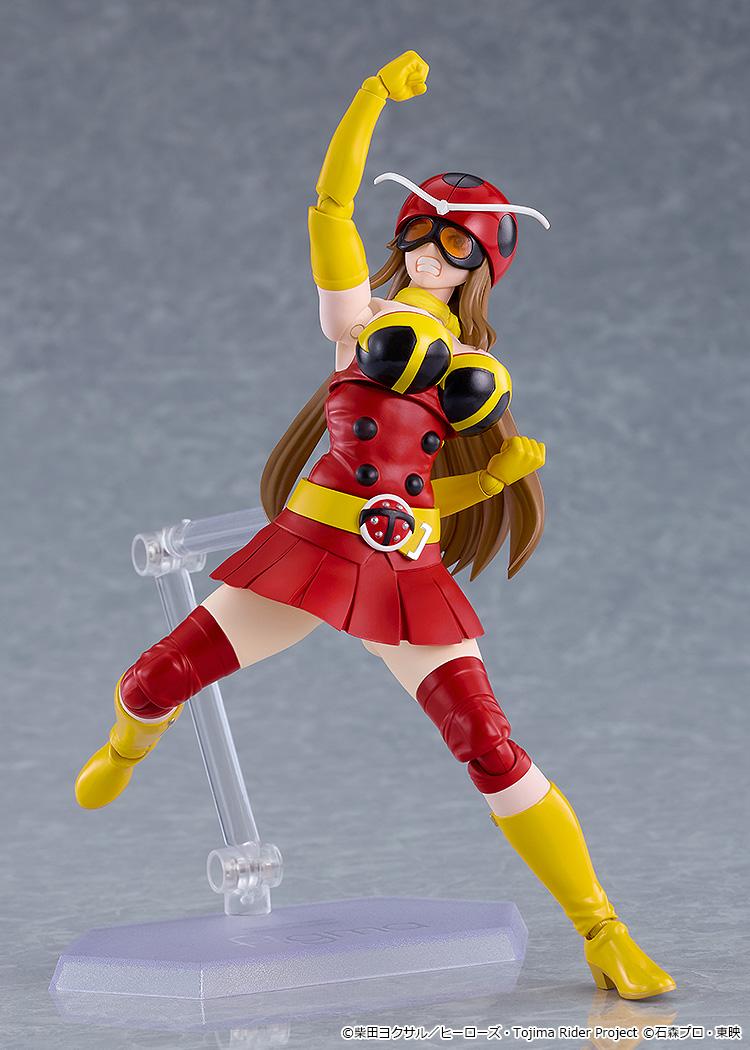 High-energy action pose of figma Yuriko Okada with gritted-teeth expression raising a fist into the air.