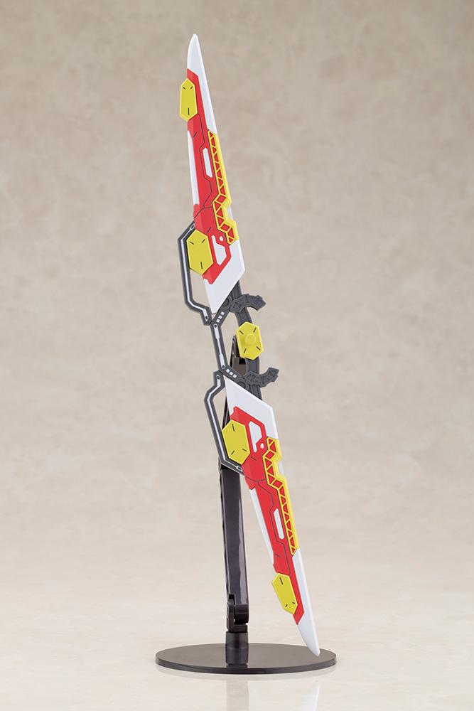 Close-up view of the red, white, and yellow Fossil Bauer double saber weapon component from the Kotobukiya Gene Stellatears model kit, displayed vertically in its sheathed configuration on a stand.