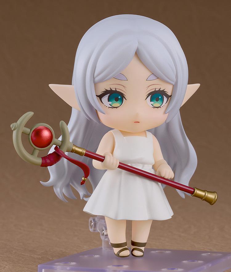 A side-facing action pose of the Frieren Apprentice Era Nendoroid holding her staff horizontally across her body.