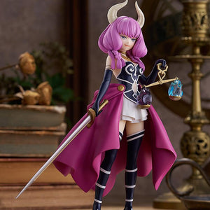Full-body front view of Good Smile Company's Aura POP UP PARADE figure displayed on a wooden surface with vintage books in the background.
