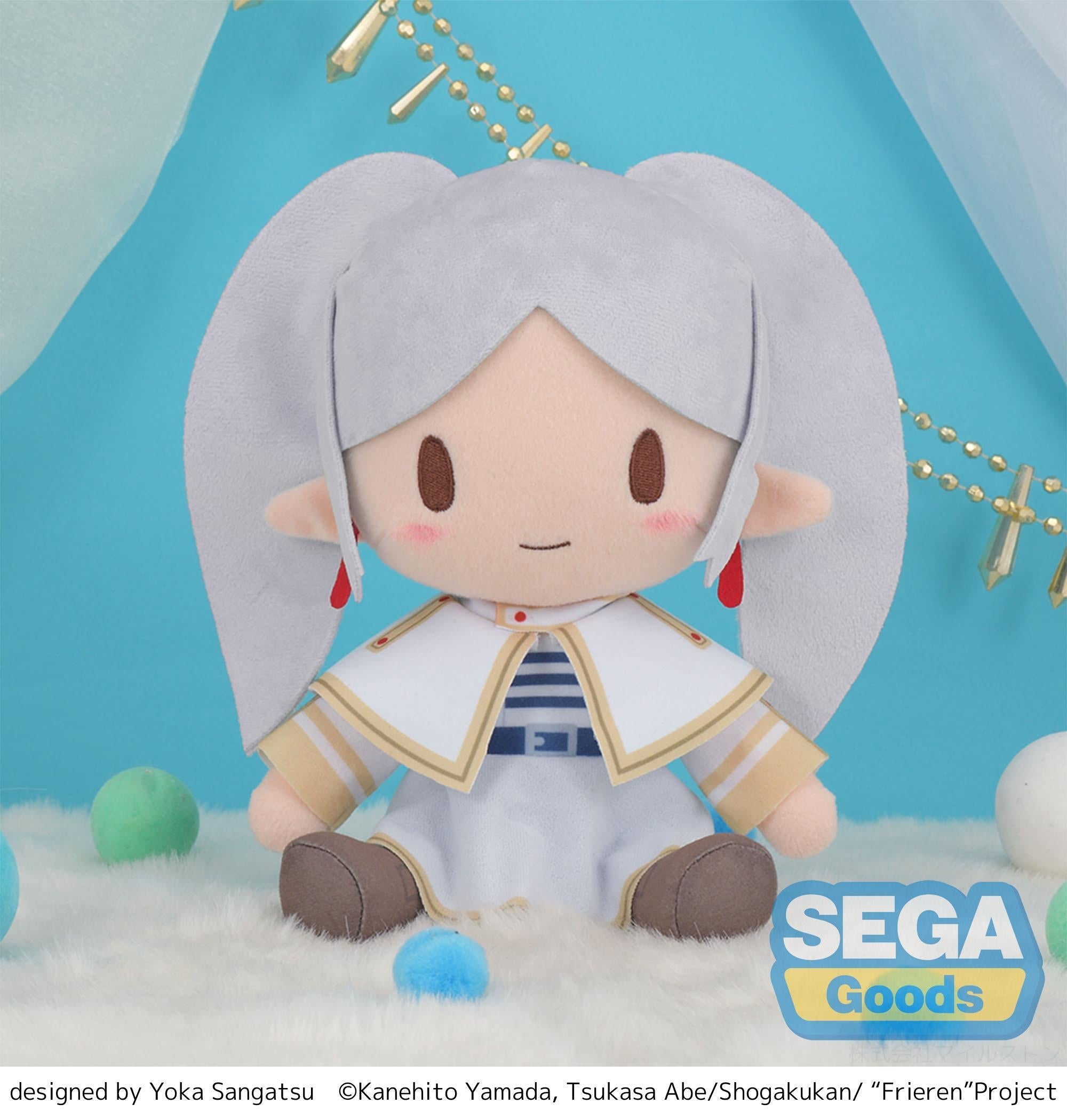 Front view of the 9-inch fuwa petit Frieren medium plush by Sega, featuring her iconic white and gold attire and pigtails, sitting on a fluffy white surface.