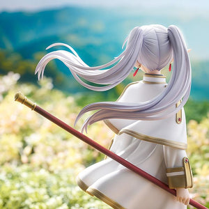 Cinematic rear view of the Frieren figure looking out over a mountain landscape.