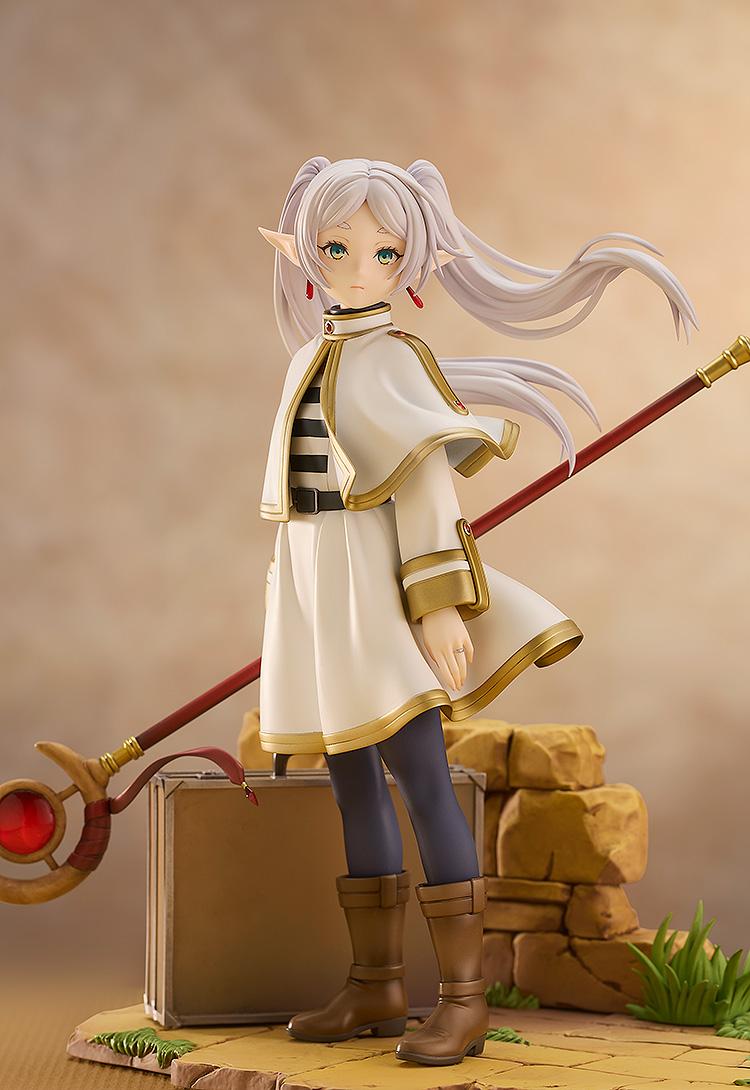 Detailed mid-shot of Frieren the mage in her signature white and gold outfit with her staff.