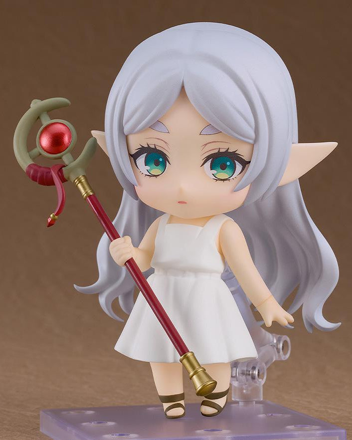 Nendoroid Frieren from Beyond Journey's End in a neutral pose holding her red and gold staff, displayed on a purple square base.