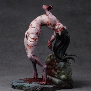 Angled profile of the Kashimashi creature statue showing its contorted, sewn-together flesh joints and grotesque physical posture.