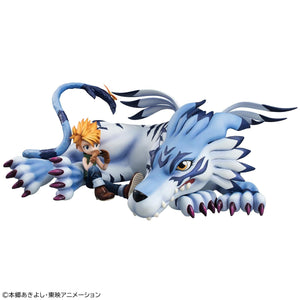 Front eye-level view of G.E.M. Series Garurumon resting on front paws with Yamato Ishida sitting beside him playing harmonica.