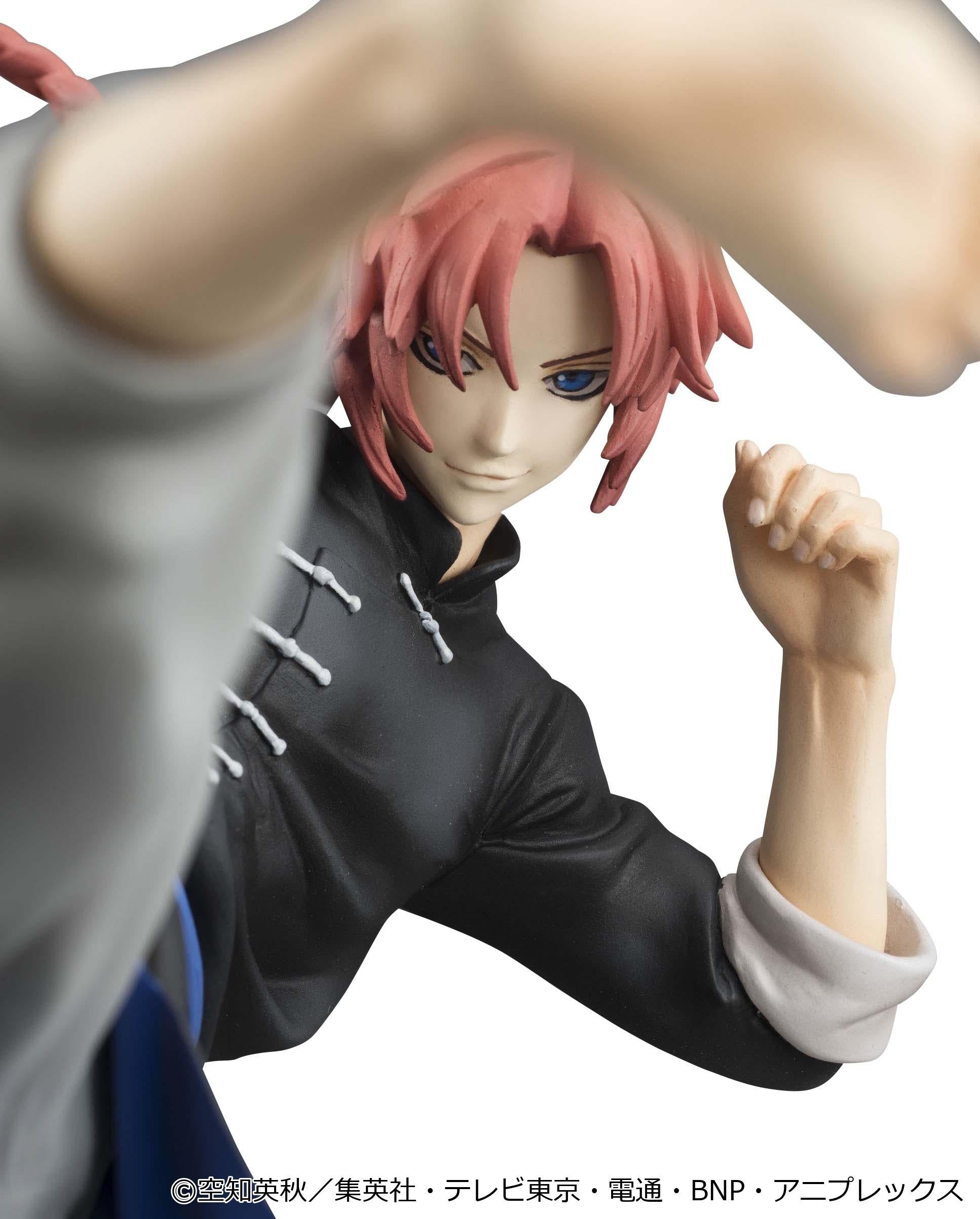 Dramatic close-up of Kamui's smiling face sculpt and blue eyes framed by his raised kicking leg.