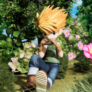 Close-up shot of the Yamato Ishida figure sitting in the grass playing his silver harmonica.