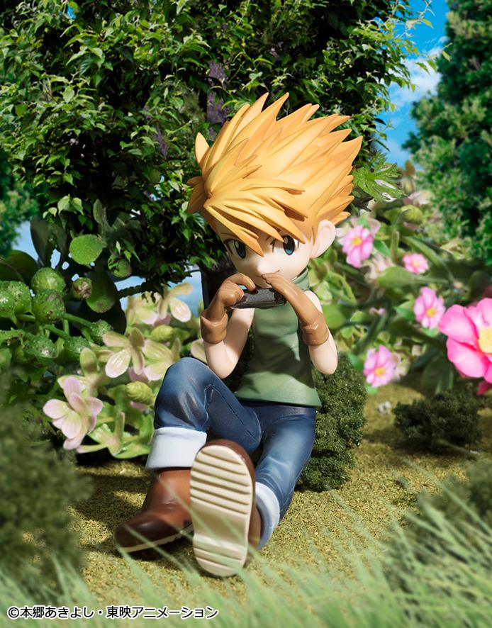 Close-up shot of the Yamato Ishida figure sitting in the grass playing his silver harmonica.
