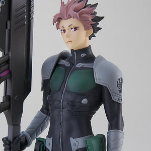 Close-up portrait of Gen Narumi showing his spiky pink and black hair, focused gaze, and the Defense Force emblem on his shoulder armor.