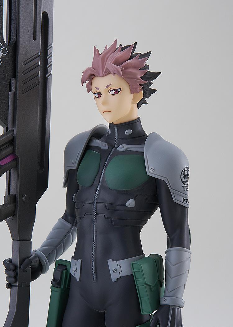 Close-up portrait of Gen Narumi showing his spiky pink and black hair, focused gaze, and the Defense Force emblem on his shoulder armor.