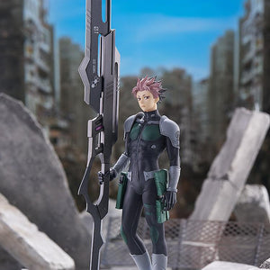 Full-body diorama display of the Gen Narumi Pop Up Parade figure standing amidst concrete rubble in a ruined post-apocalyptic city backdrop.