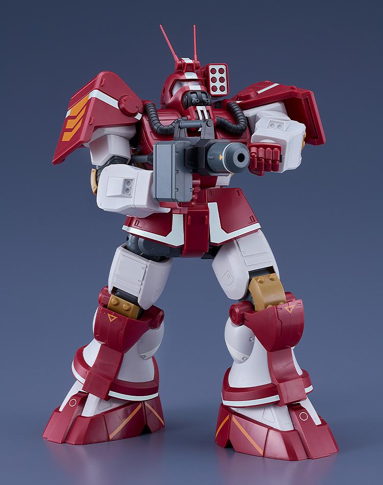 Dynamic front action pose of the Blockhead Combat Armor plastic model kit wielding its heavy mag launcher weapon with both hands in a firing stance.