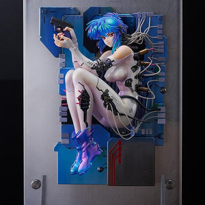 Side profile shot of the Motoko Kusanagi figure, showcasing the three-dimensional display and the cables running from her body to the base.