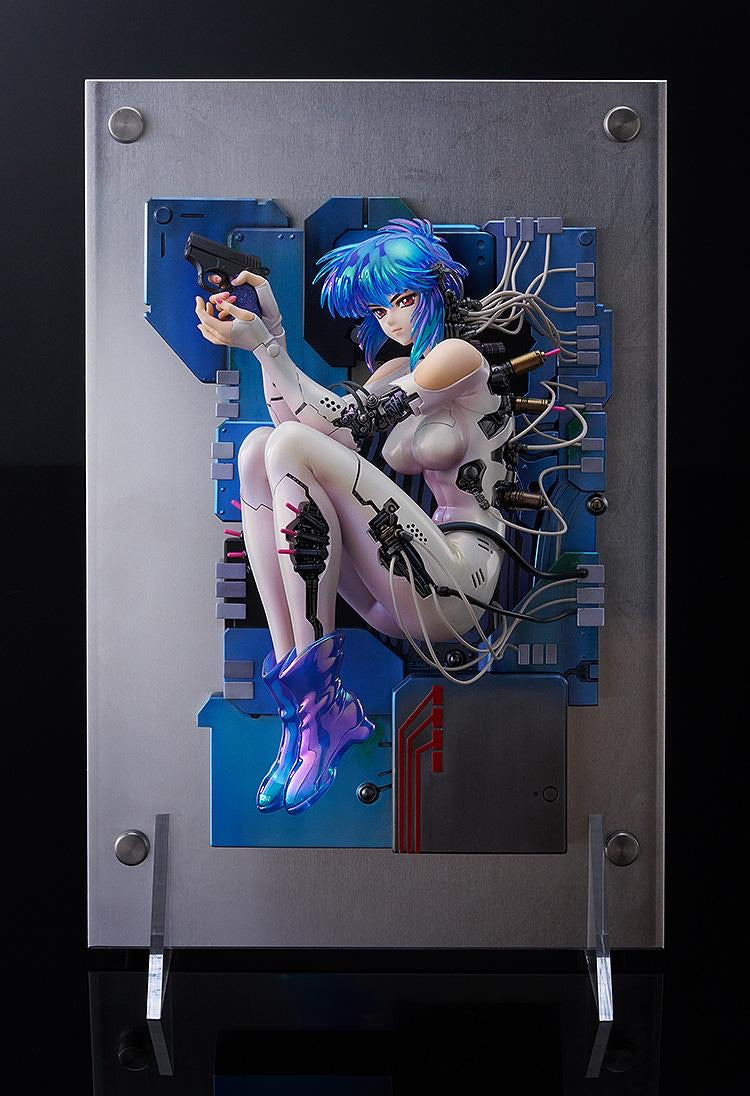 Side profile shot of the Motoko Kusanagi figure, showcasing the three-dimensional display and the cables running from her body to the base.