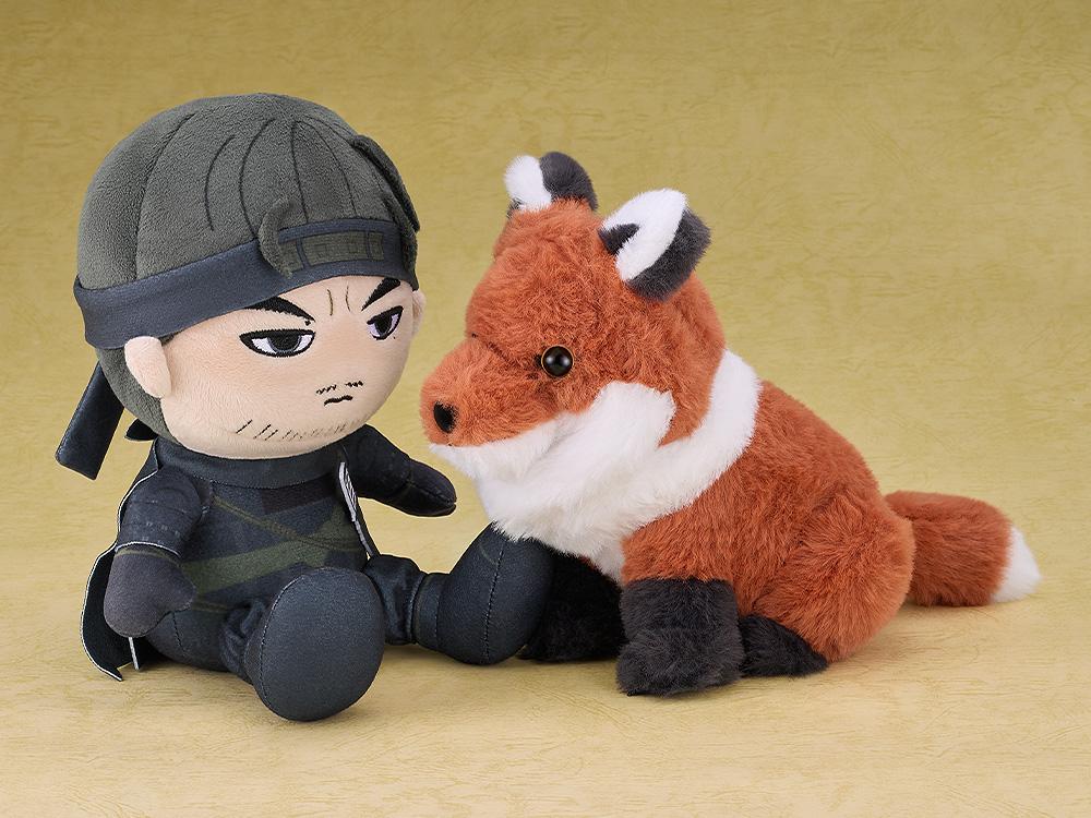 Side view of the fox plushie sitting next to a Jin Sakai plushie, recreating a companion scene from the Ghost of Tsushima game.