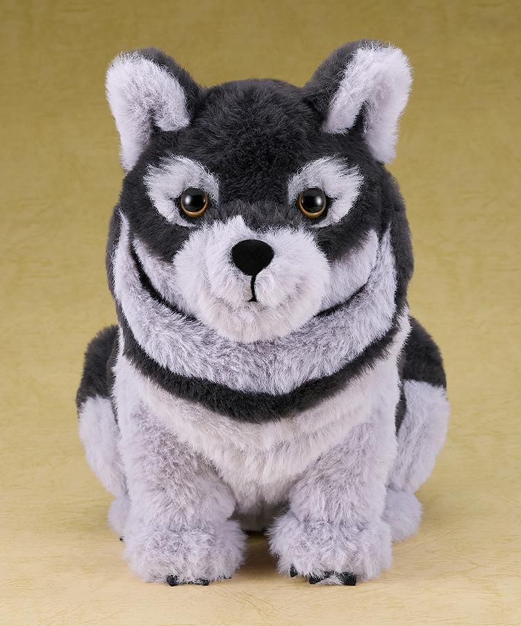 Full-body studio shot of the sitting wolf plushie, a soft polyester companion from the Ghost of Yotei video game.