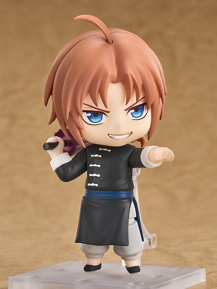 Dynamic combat pose of the Gintama Kamui Nendoroid figure displaying a smirking combat face plate and holding a folded umbrella.