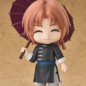Full-body studio display of the Kamui Nendoroid figure from Gintama featuring his grinning face plate and holding an open purple umbrella.