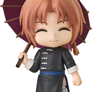 Cutout image of the Gintama Kamui Nendoroid figure smiling with closed eyes while holding an open purple umbrella on a plain white background.