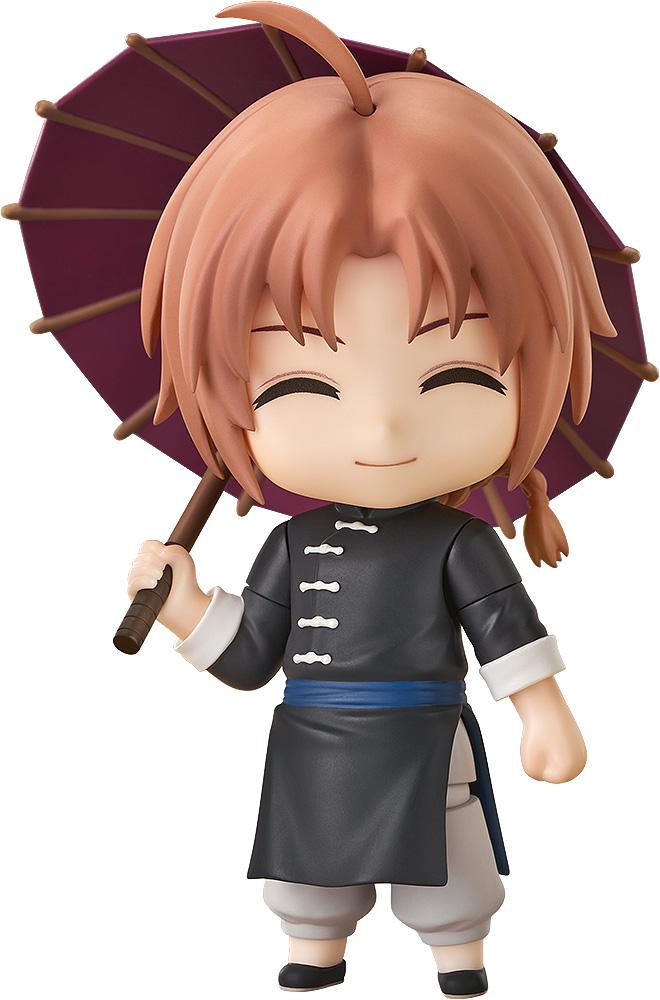 Cutout image of the Gintama Kamui Nendoroid figure smiling with closed eyes while holding an open purple umbrella on a plain white background.