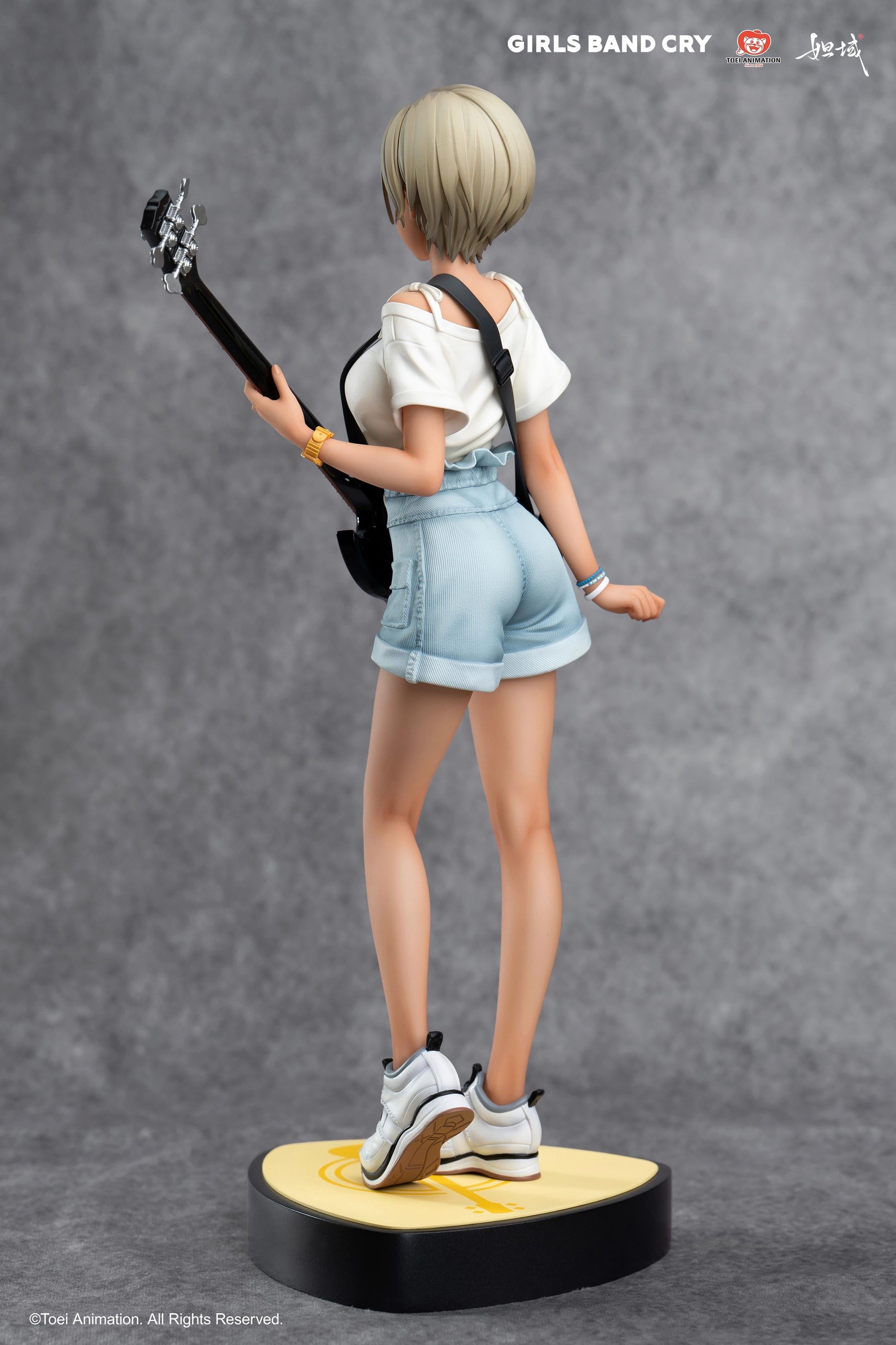 Rear view of Rupa figure showcasing the high-waisted jean shorts and short blonde hair sculpt.
