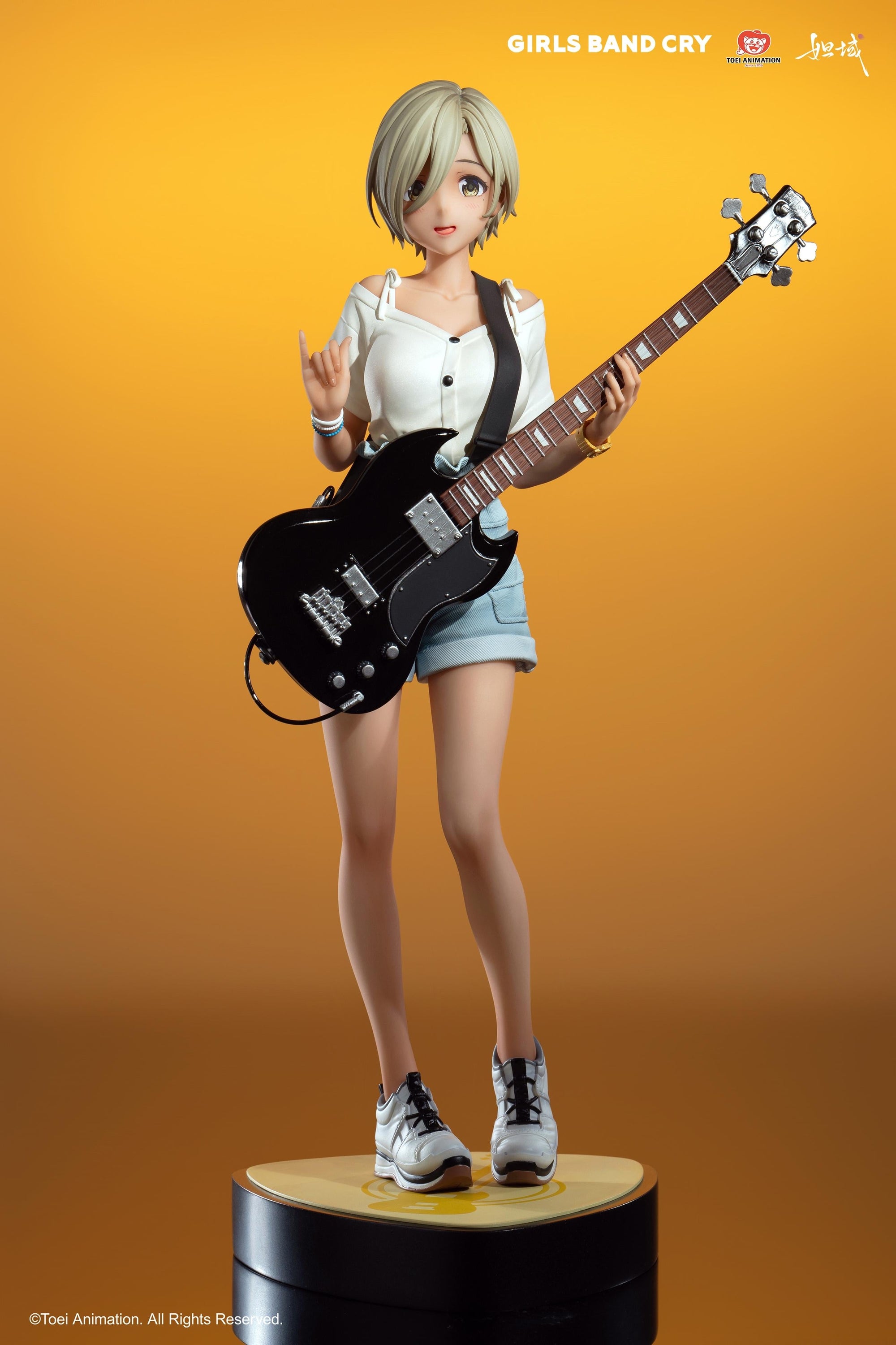 Rupa 1/7 scale figure in a dynamic rock pose with a "horns up" hand gesture against a golden background.