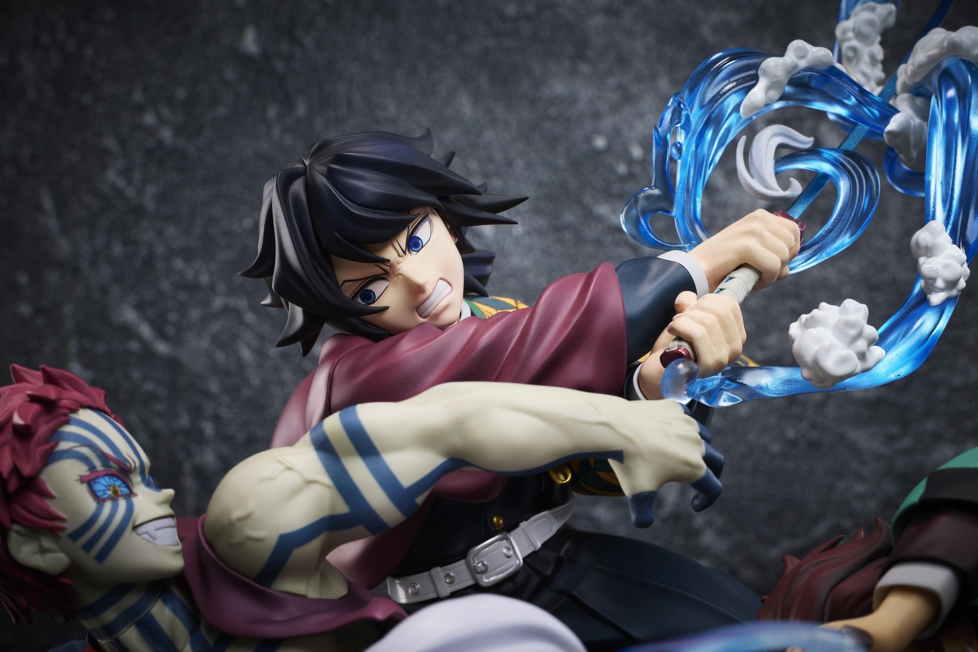 Tight close-up of Giyu Tomioka's determined face sculpt and translucent blue water effect on the Aniplex figure