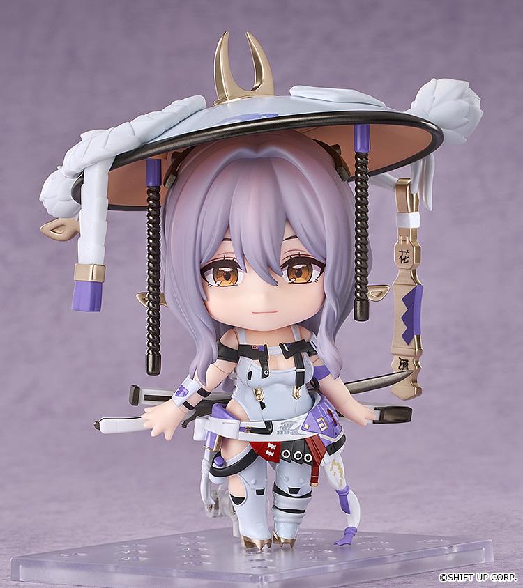Full-body product shot of the Goddess of Victory: Nikke Scarlet Nendoroid chibi figure standing on a clear display base in her signature white-and-purple outfit.