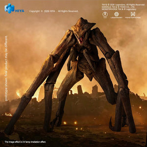 Low-angle front view of the MUTO figure standing aggressively with mouth open against an orange smoke and burning skyline backdrop.