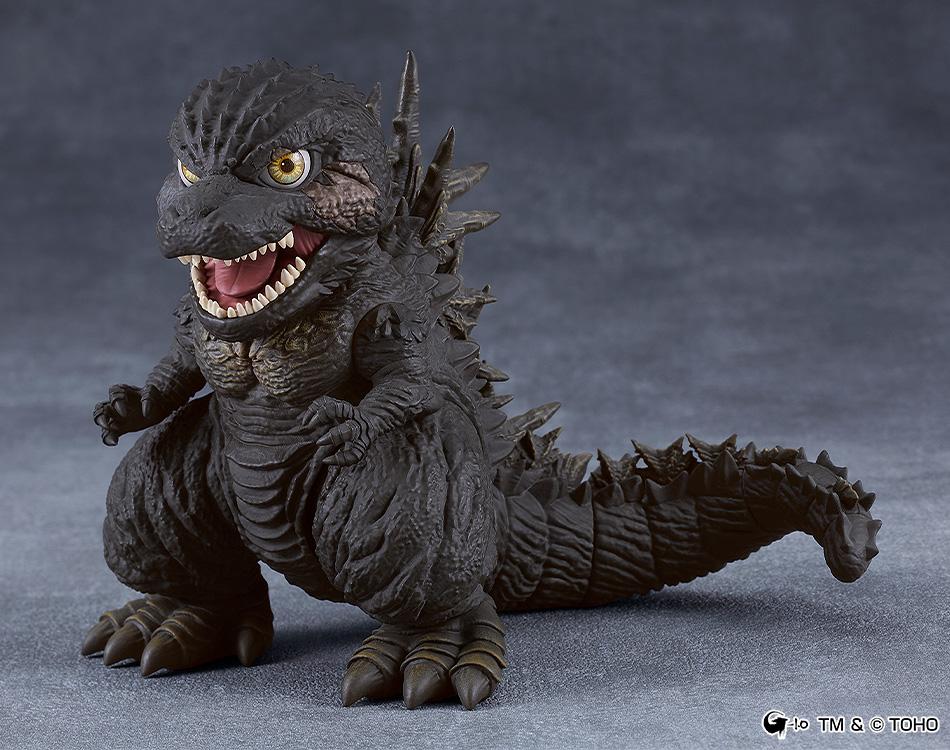 Standing display pose of the Godzilla Minus One 2023 Nendoroid figure with detailed dark textured skin against a dark gray background.