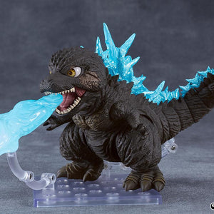 Action pose of the Godzilla 2023 Nendoroid figure blasting a blue atomic breath ray effect piece attached to a clear stand.