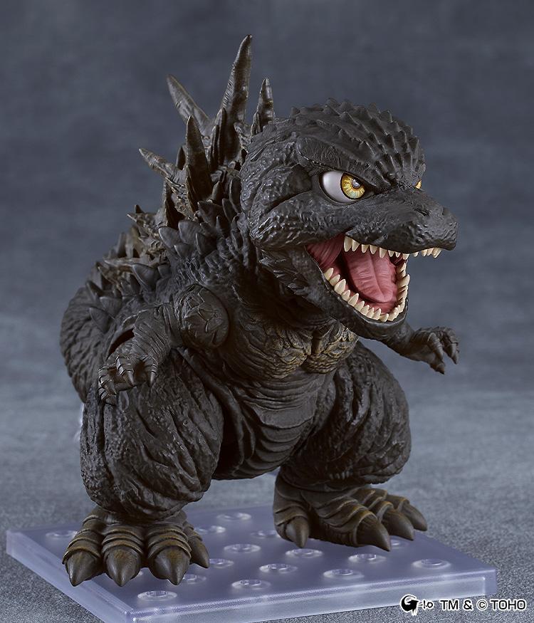 Three-quarter view of the Godzilla Minus One Nendoroid standing on its clear square display stand with an open mouth.