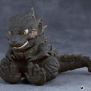 Cute sitting pose of the Godzilla 2023 Nendoroid figure showcasing its large clawed feet and articulated tail.