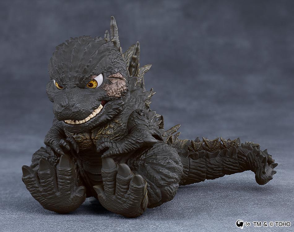 Cute sitting pose of the Godzilla 2023 Nendoroid figure showcasing its large clawed feet and articulated tail.