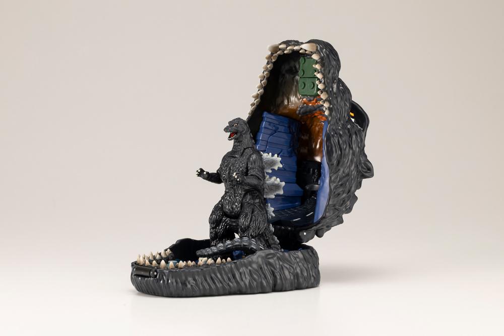 Open Godzilla pocket playset displaying Godzilla figure standing inside the lower jaw base.