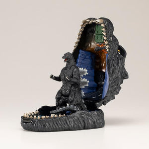 Open Godzilla pocket playset displaying Godzilla figure standing inside the lower jaw base.