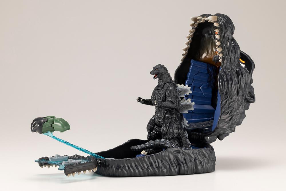 Opened Godzilla playset featuring the miniature Super X II vehicle mounted on the blast effect piece.