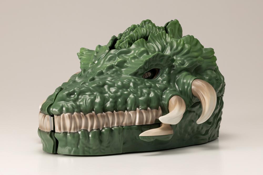 Closed Biollante pocket toy side view showing plant beast head sculpt and tusks.